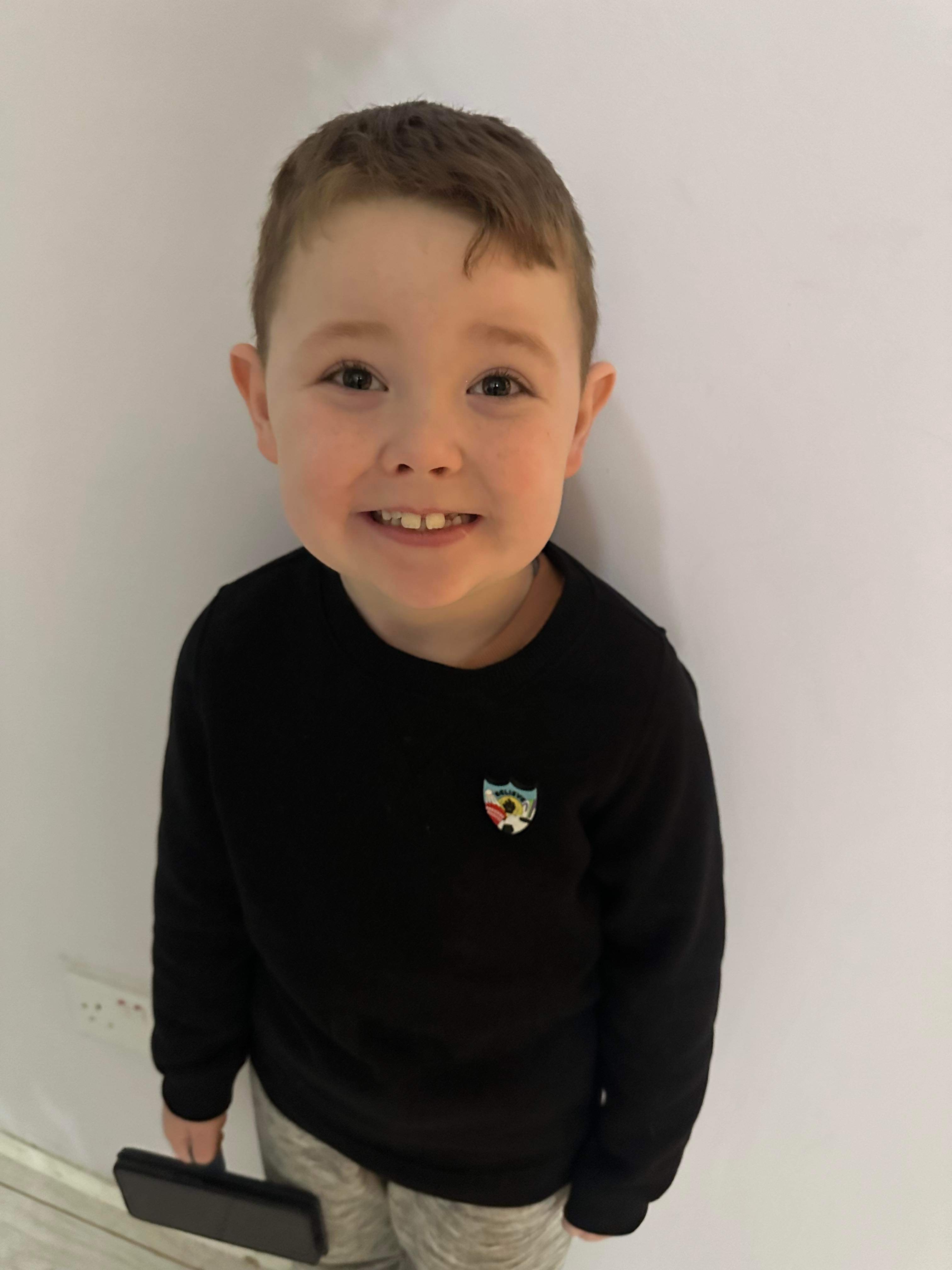 Oliver wearing his Blue Peter sports badge